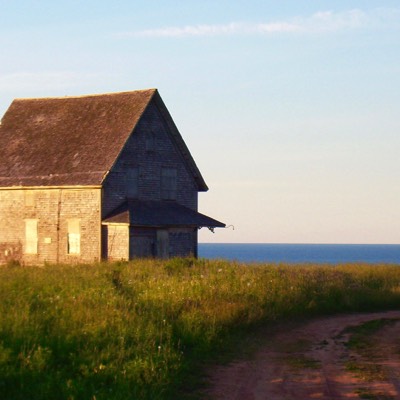 A lonely, abandoned building on Cape Tryon Road. You can see the red clay road, at the end of which is a drop. 