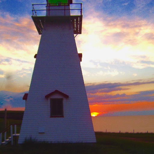 Cape Tryon lighthouse in the foreground, with the spectacular sunset over the water behind. 