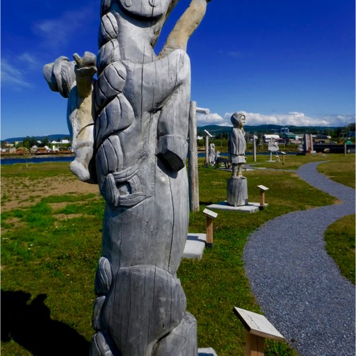 Stylized sculpture of a horse running straight up (vertically), with a rider on its back. 