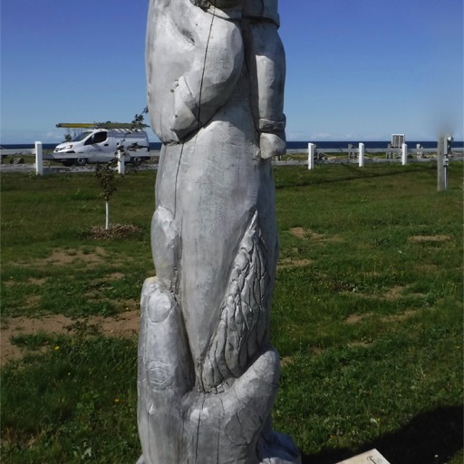 Sculpture of a child embracing a woman. 